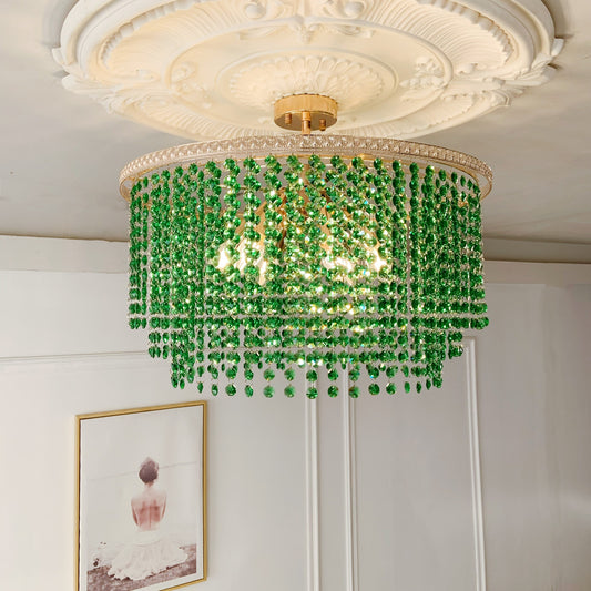 Green beaded chandelier hanging from a decorative ceiling fixture.