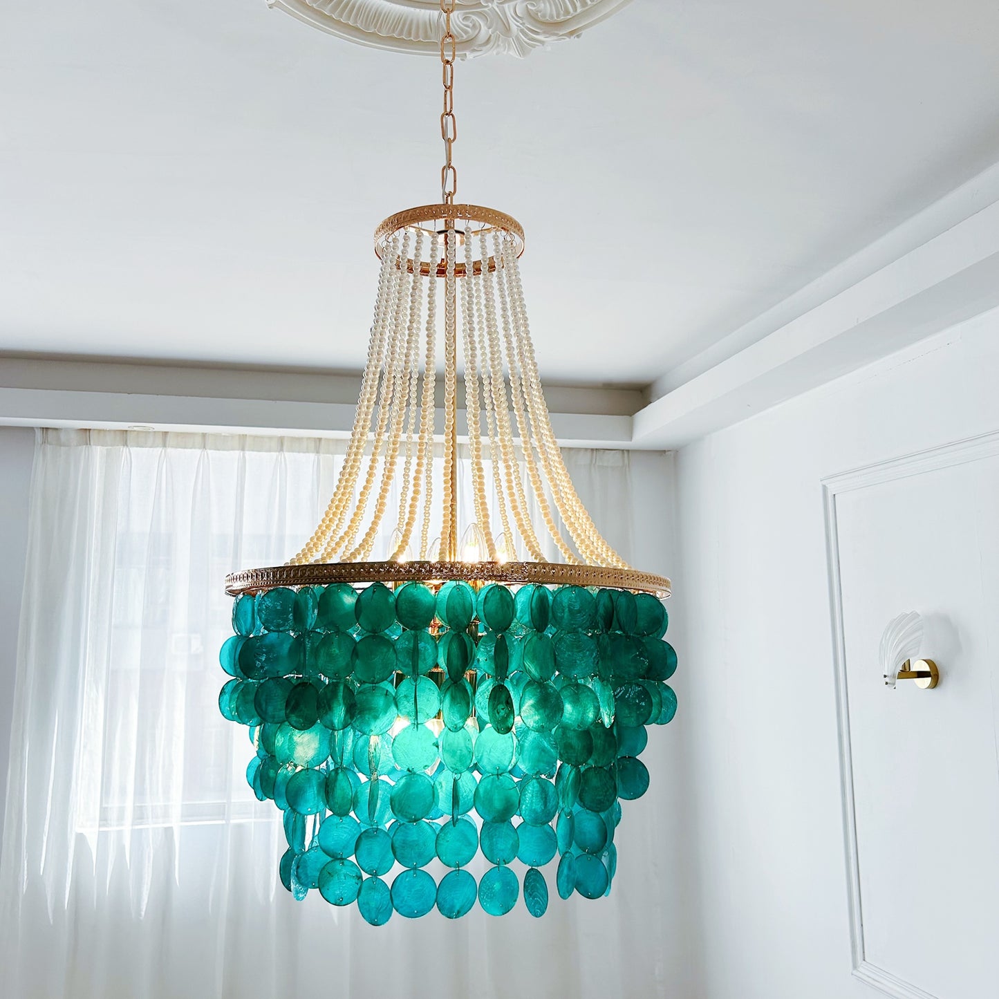 Luxury coastal chandelier with blue capiz shells and pearl accents for grand foyer