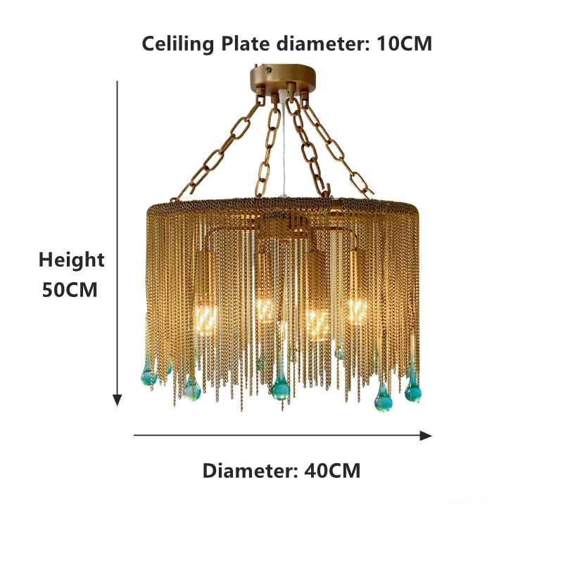Glass drop chandelier close up showing brass finish and blue tinted crystal details