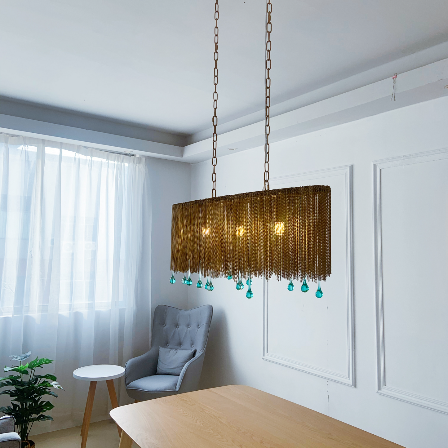 Brass and crystal linear light close up showing teardrop details and elegant design