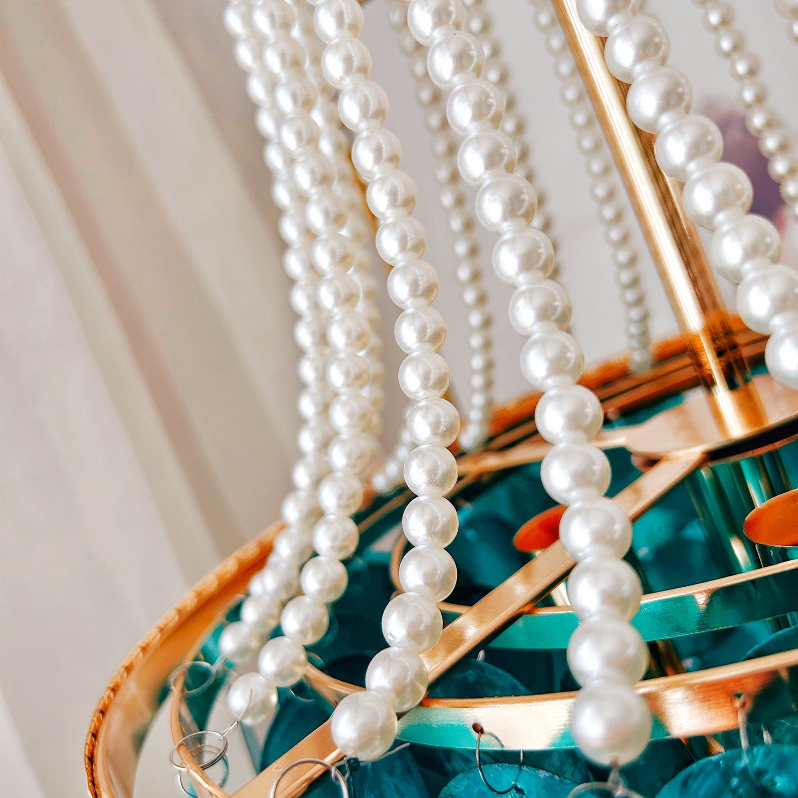 Blue capiz shell chandelier close up showing handcrafted pearl details and warm brass