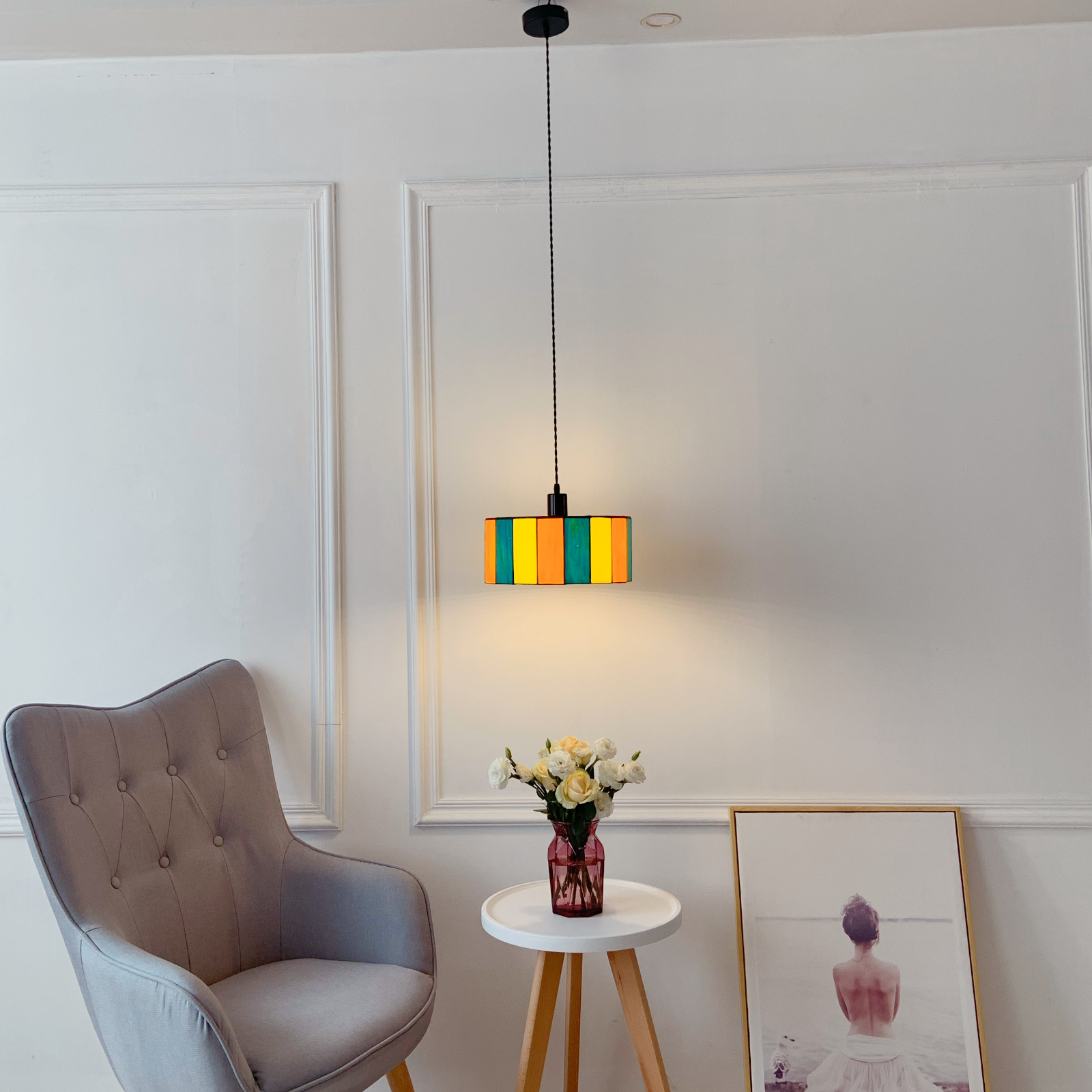 Boho colorful glass pendant with rainbow mosaic creating vibrant lighting in dining room