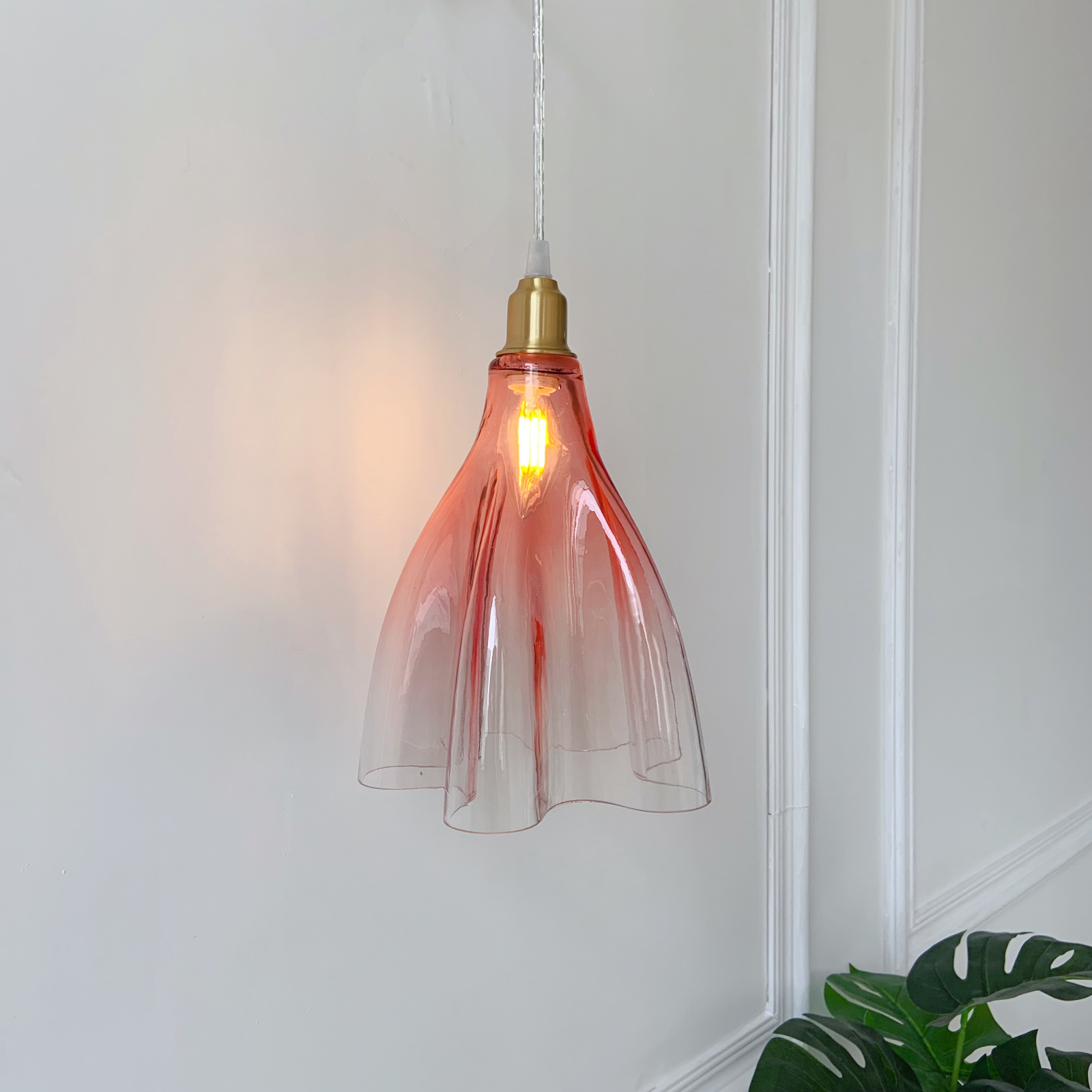 Handcrafted ruffled glass wall sconce close up showing brass details and vintage design