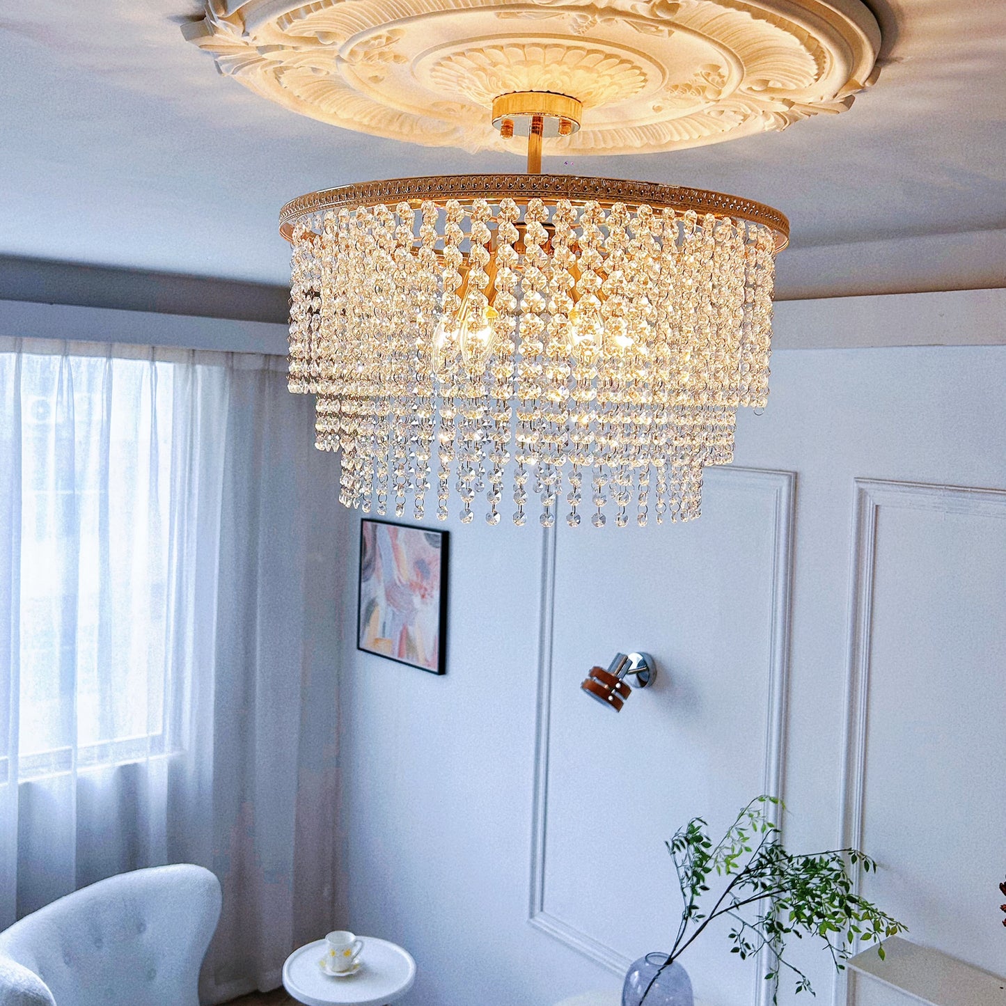 Luxury gold chandelier with sparkling crystal accents hanging in elegant dining room
