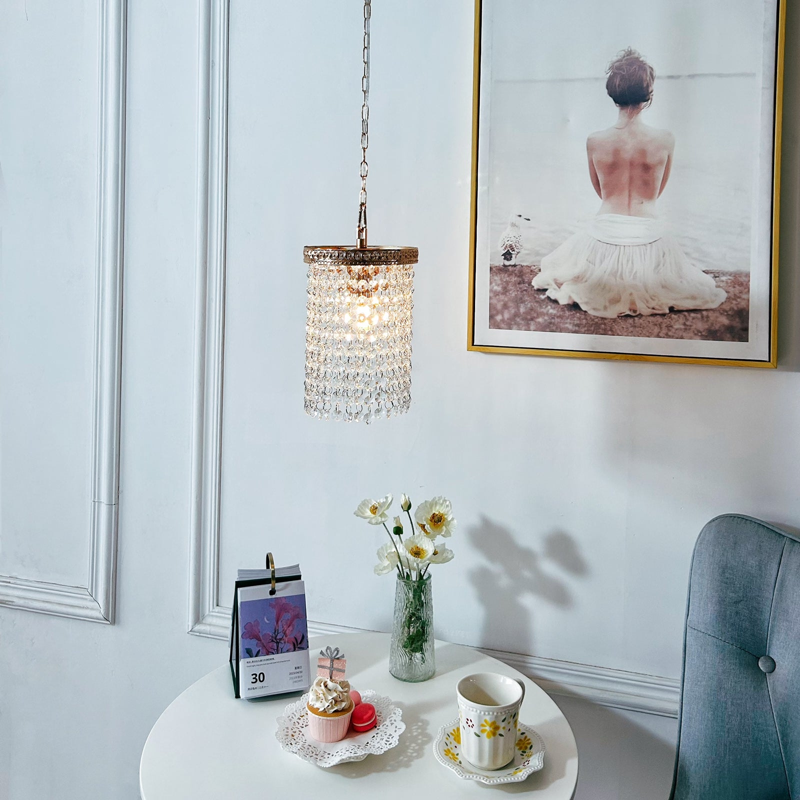 Luxury gold pendant light with sparkling crystals hanging over breakfast nook
