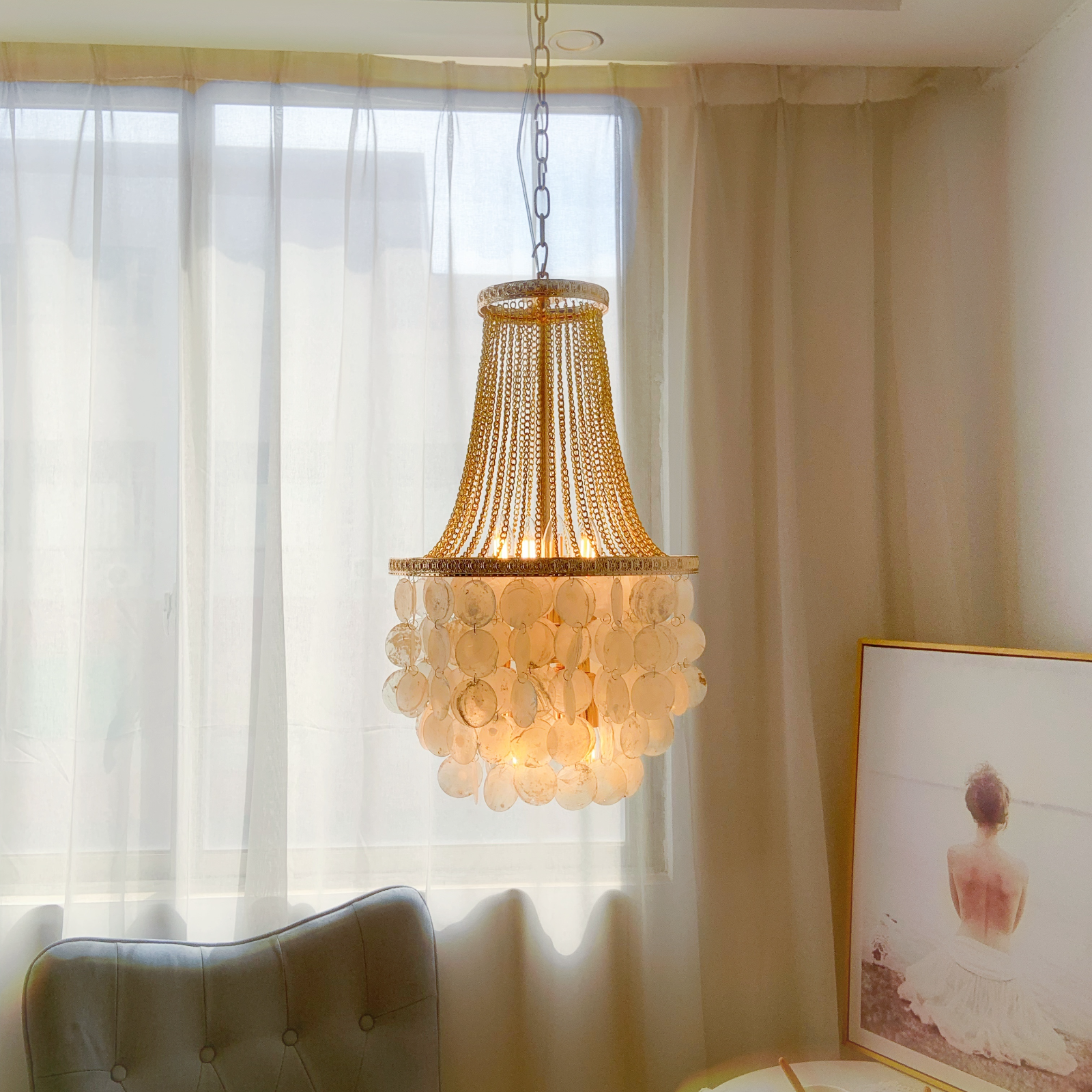Coastal chandelier with layered shells perfect for foyer entryway and bedroom
