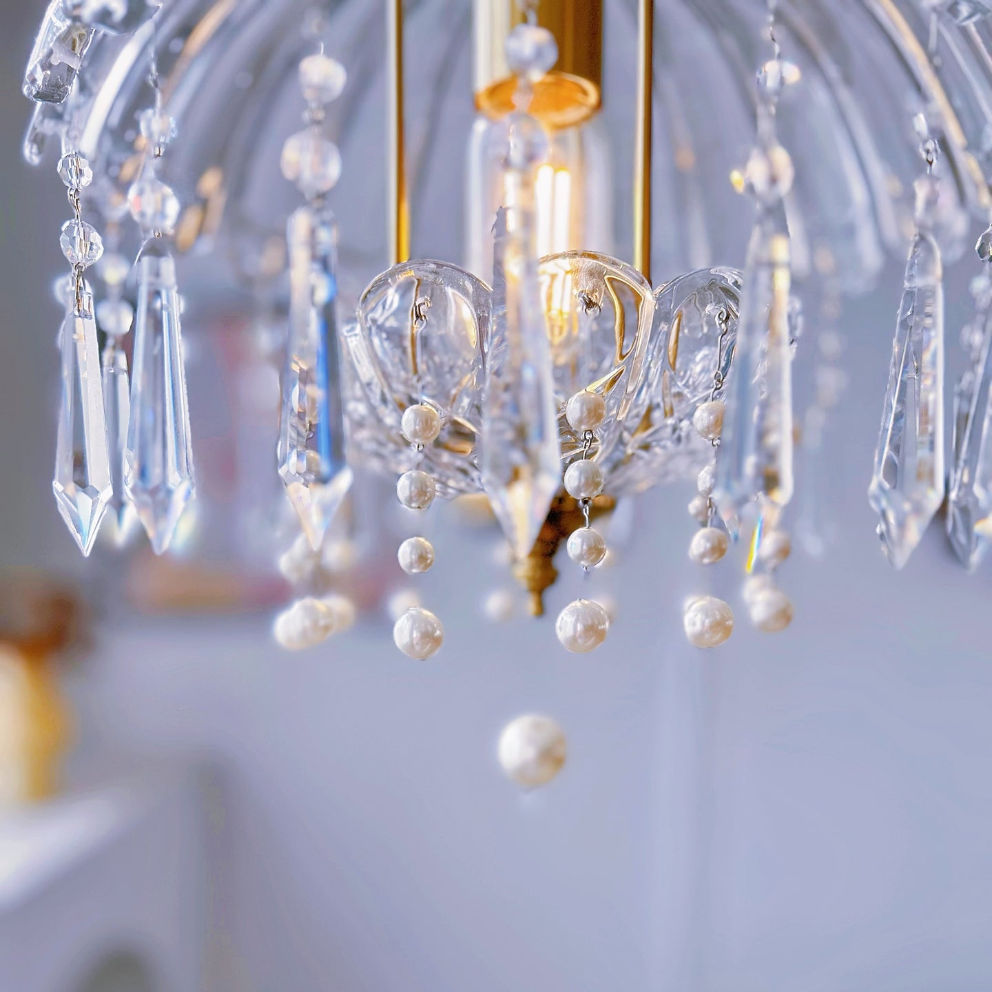 French country style crystal pendant light with warm brass creating cozy dining room lighting
