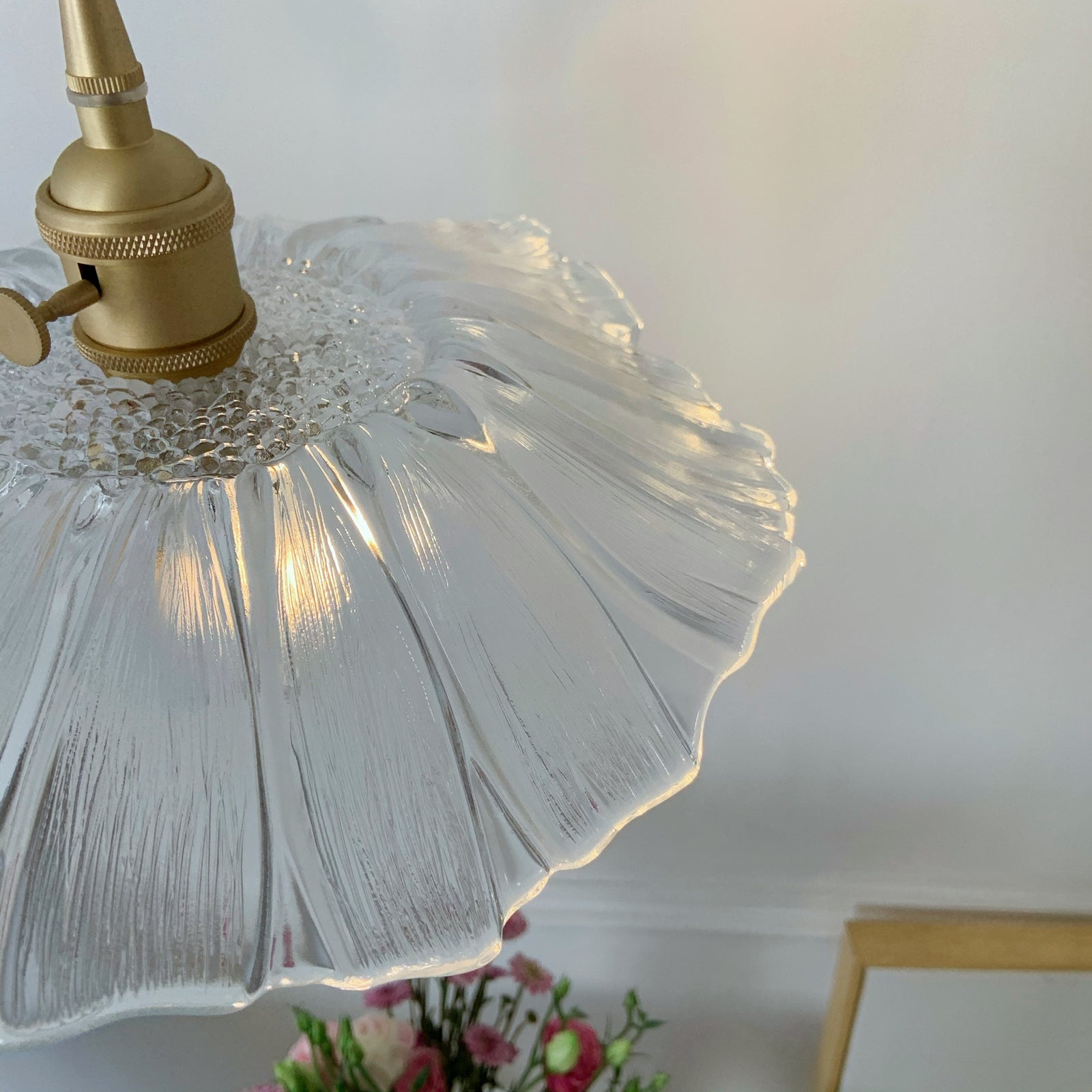 Clear glass pendant creating bright task lighting in modern farmhouse kitchen
