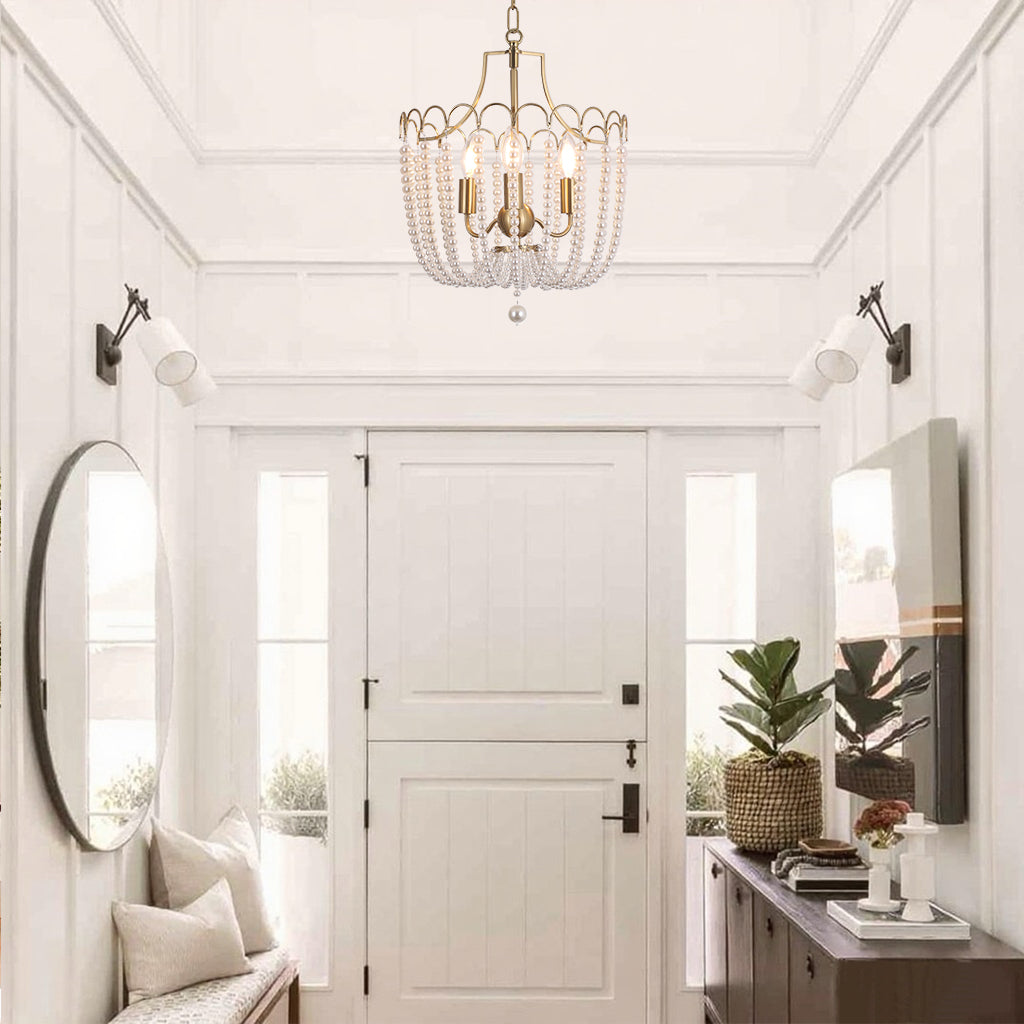 Gold pearl chandelier creating warm ambient lighting in elegant entryway and foyer