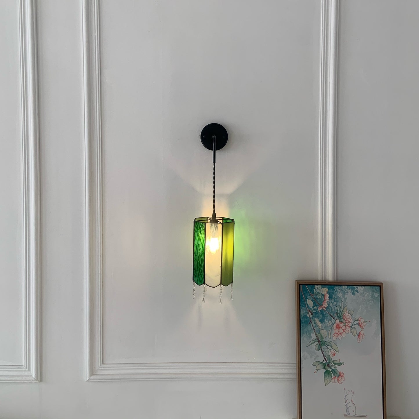Vintage Tiffany wall light with colorful art glass creating warm ambient lighting