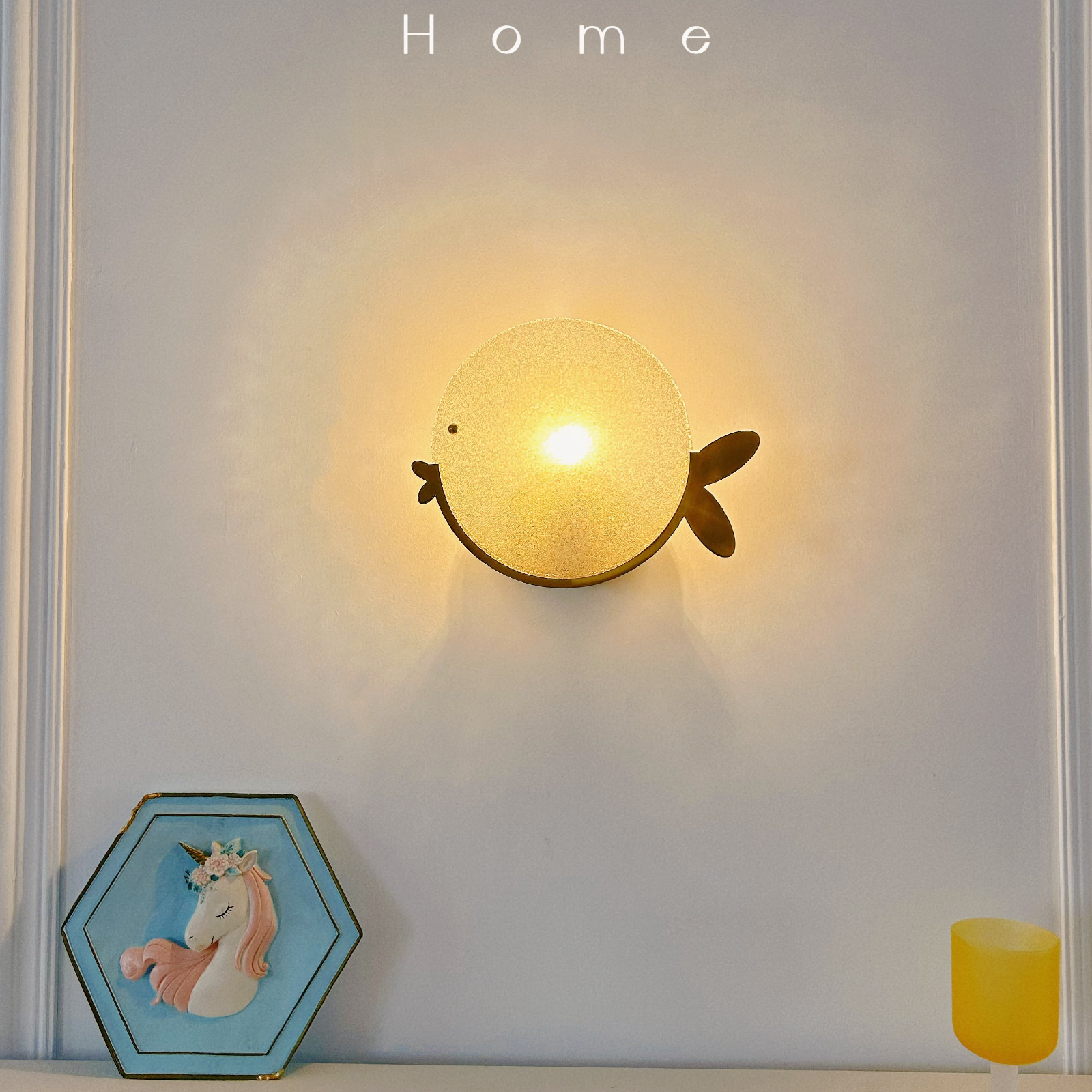 Unique fish wall light with brass finish creating whimsical lighting in kids room