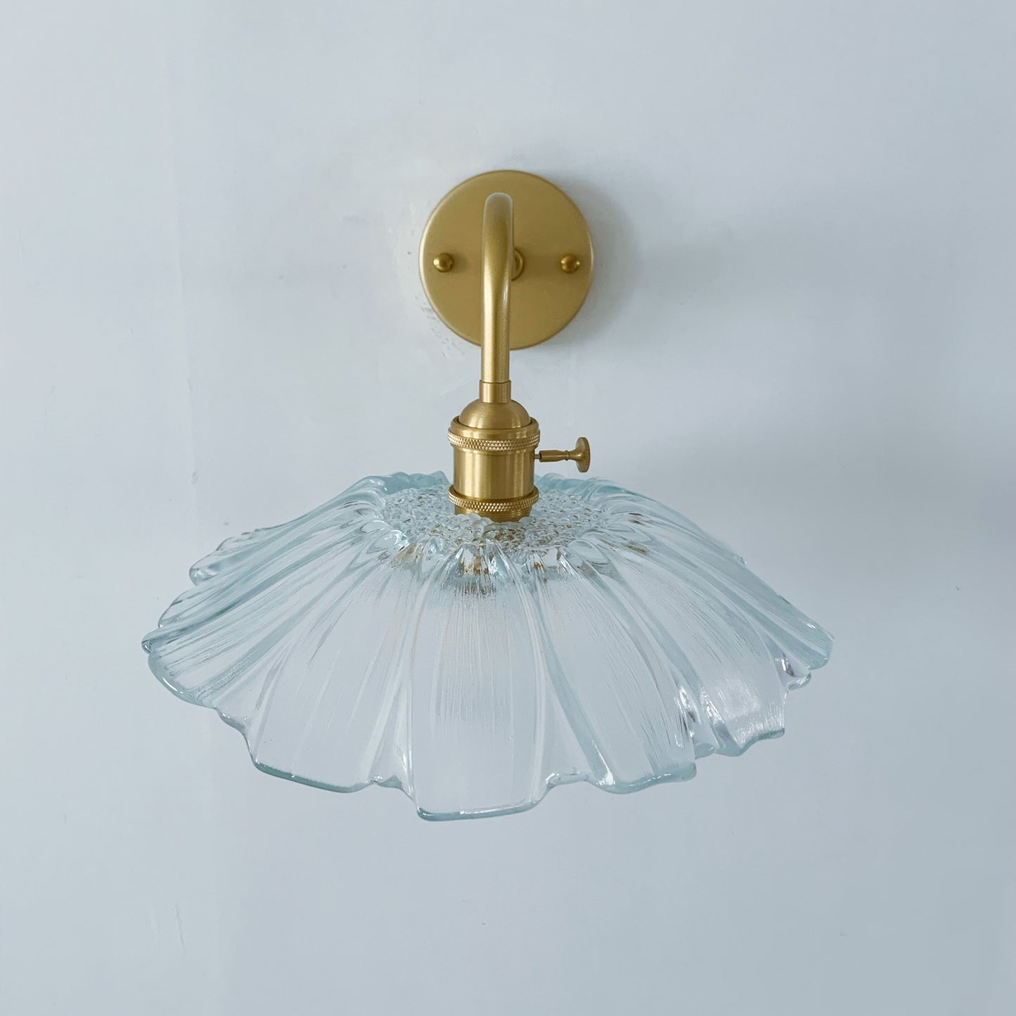 Modern wall sconce with glass shade perfect for bedside lighting and accent walls