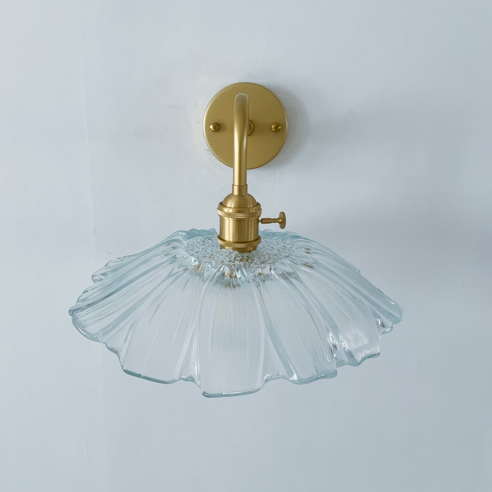 Modern wall sconce with glass shade perfect for bedside lighting and accent walls