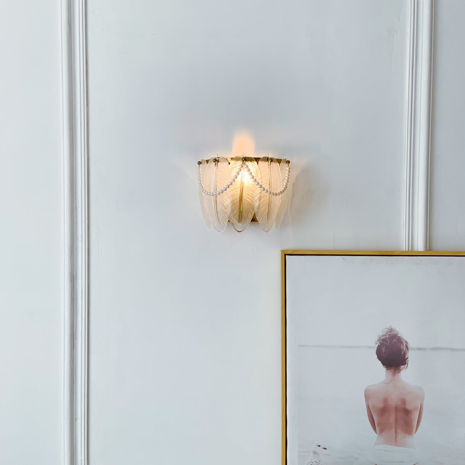 Decorative wall light fixture with a framed