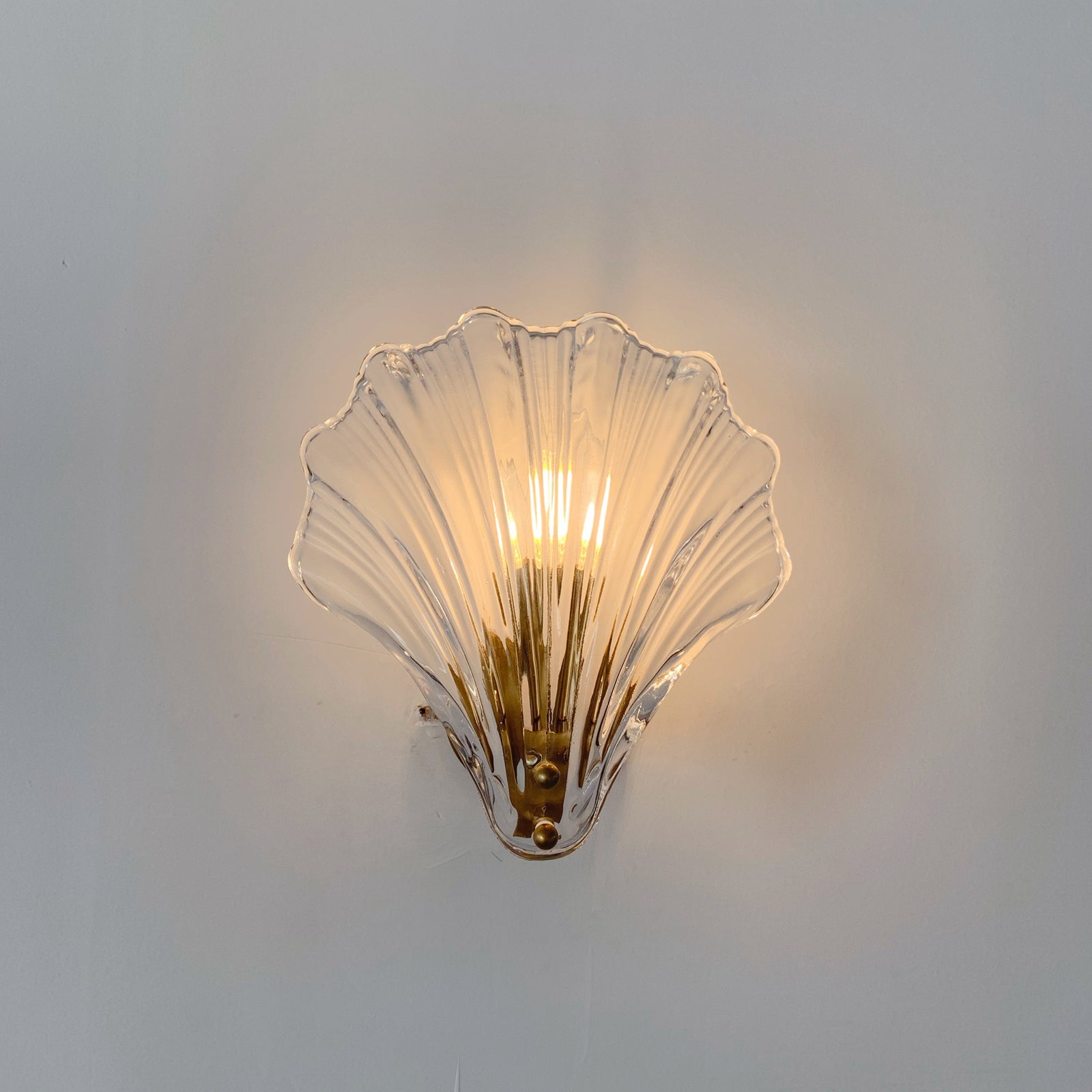 Brass clear glass wall sconce - handcrafted shell wall fixture detail close-up