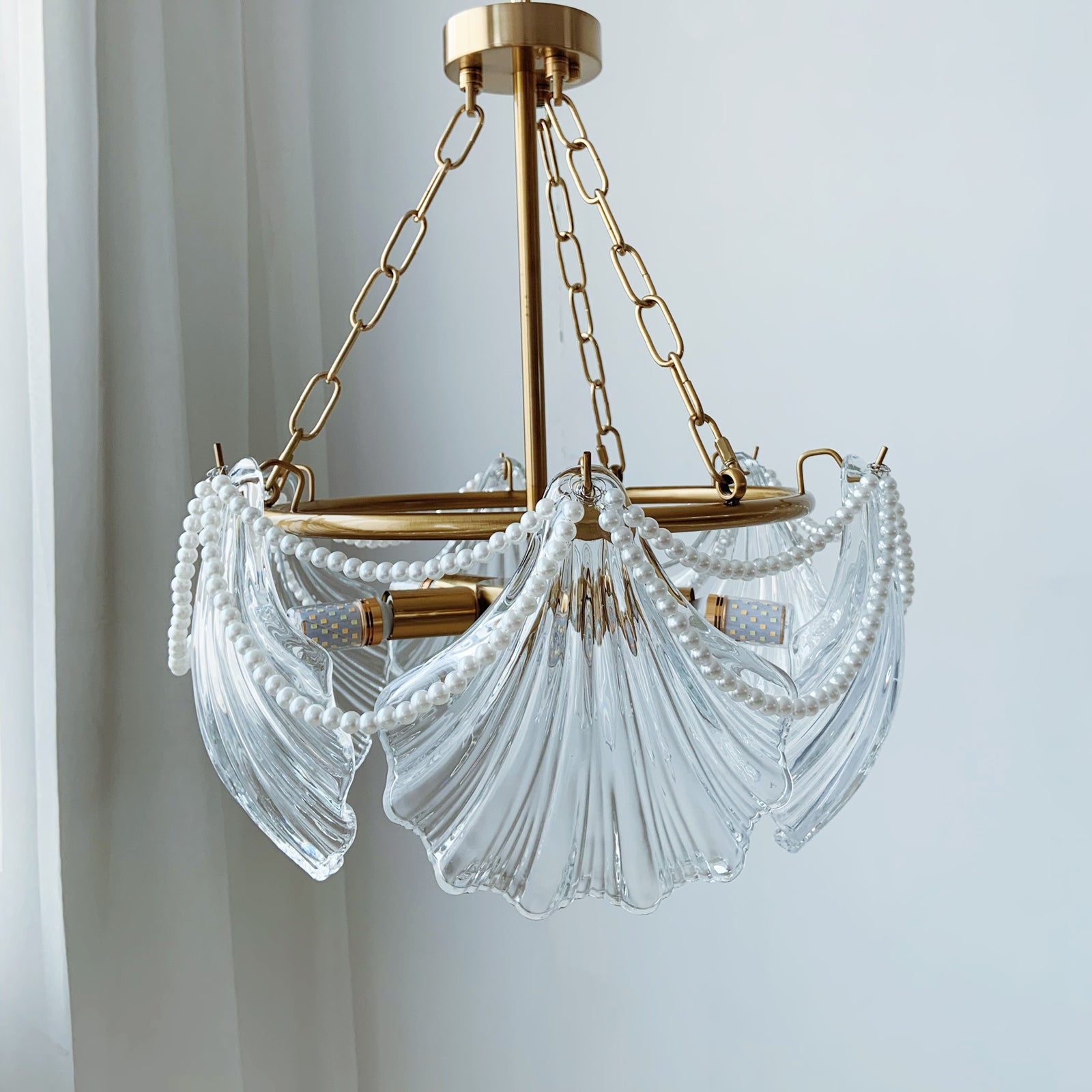 Chandelier with clear glass shades and gold metal accents 