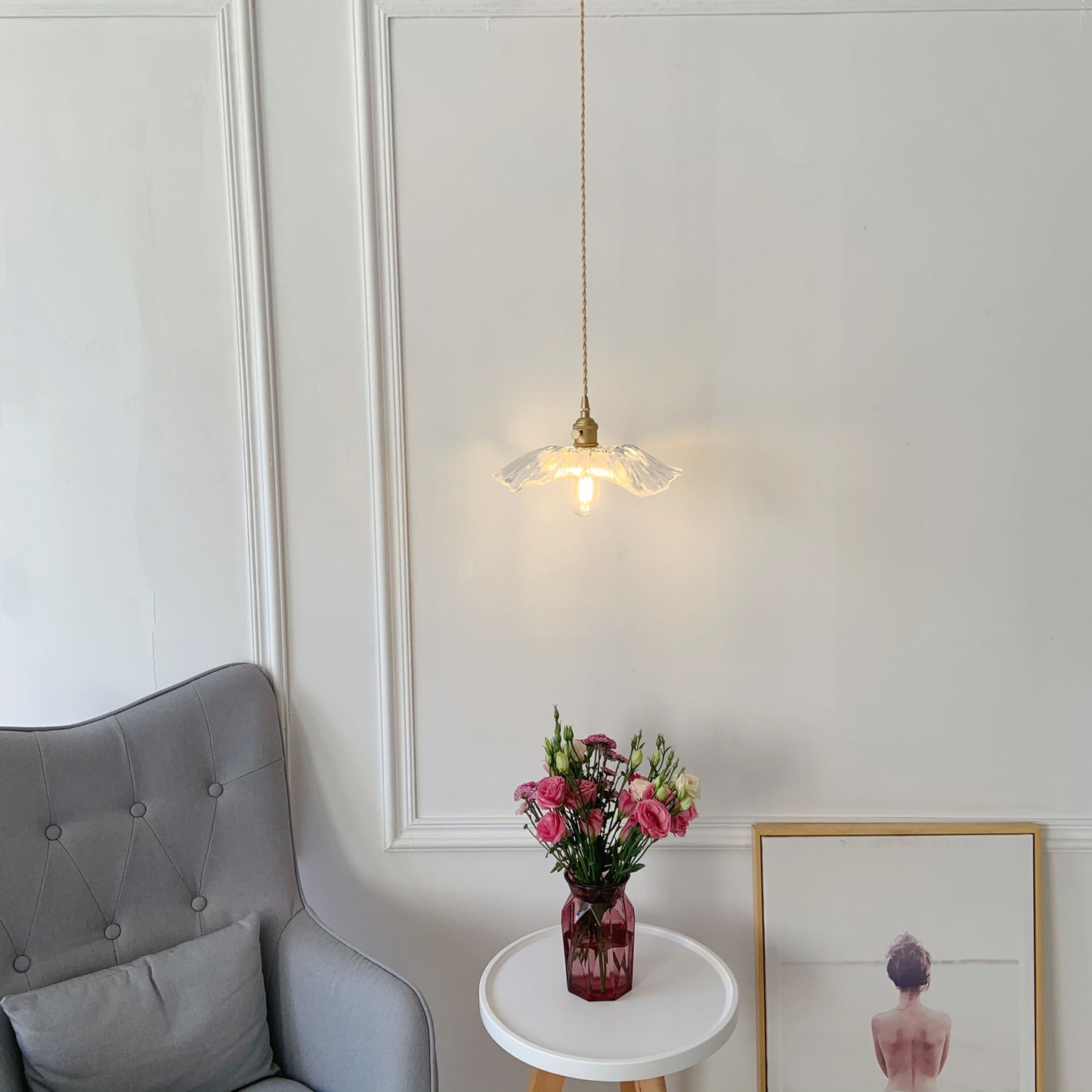 Modern glass pendant with brass finish hanging over coffee bar and breakfast nook