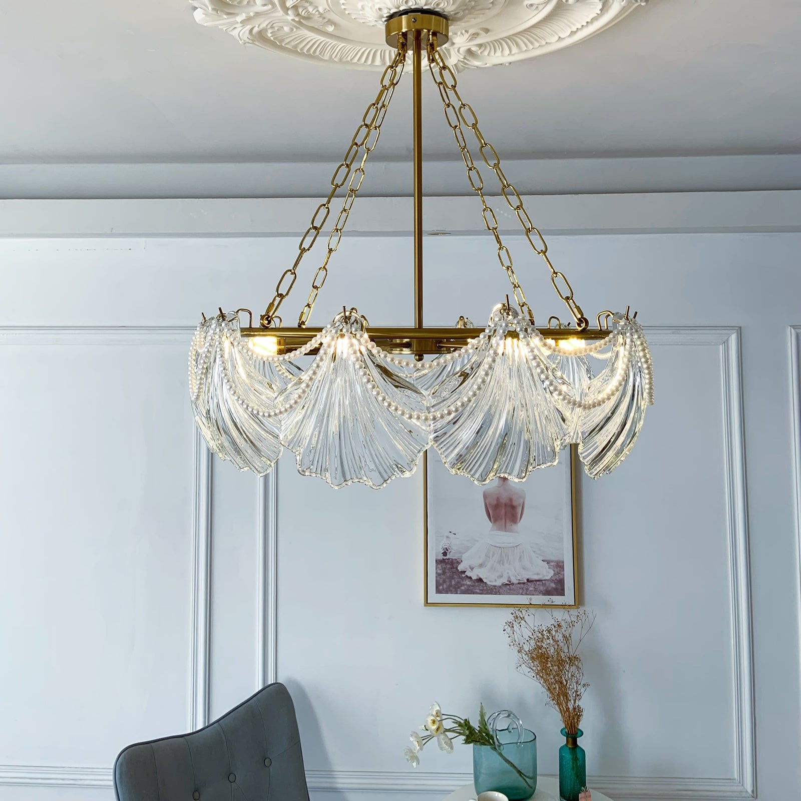 Glass Chandelier with pearls hanging in a room 
