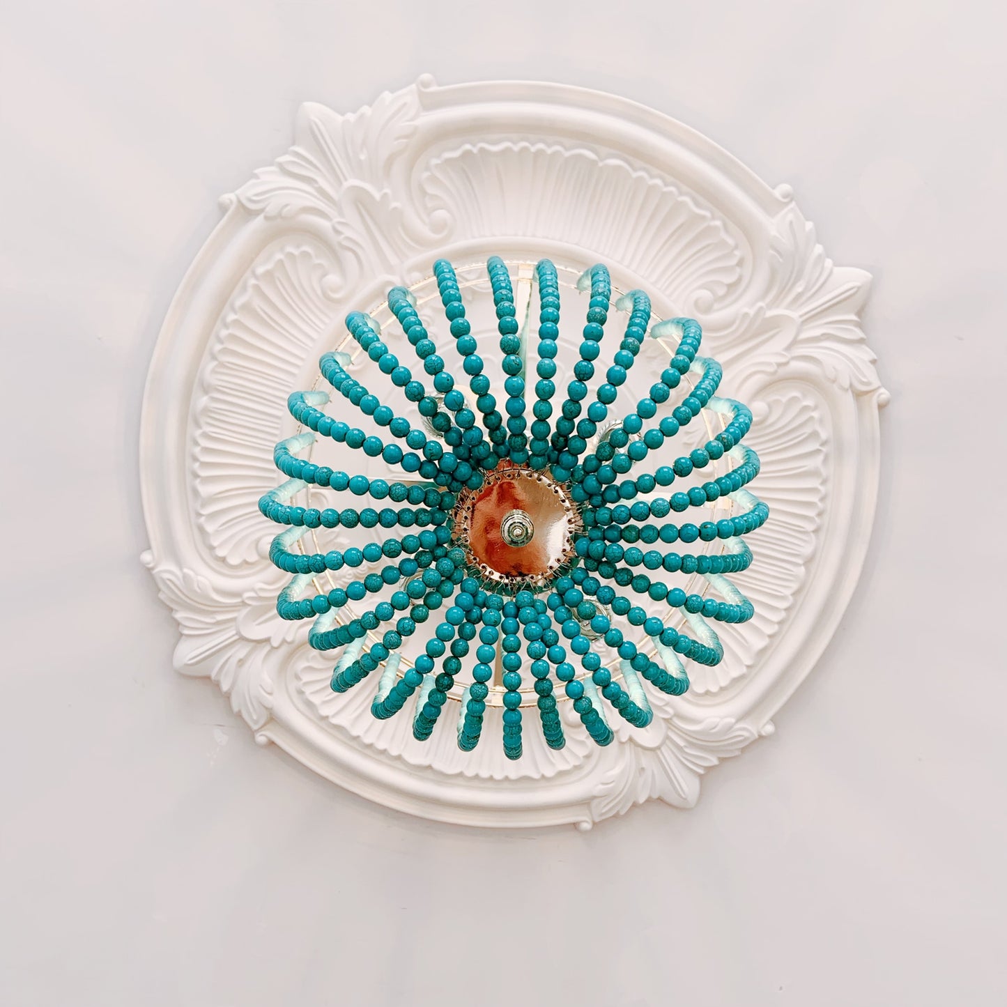 Decorative ceiling medallion with turquoise beaded design