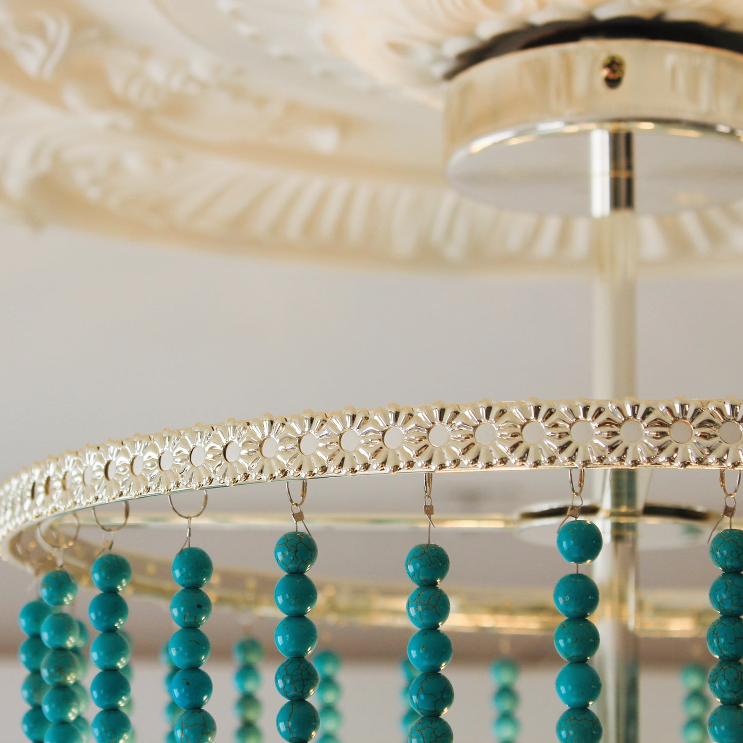 Turquoise beaded chandeliers hangin ceiling