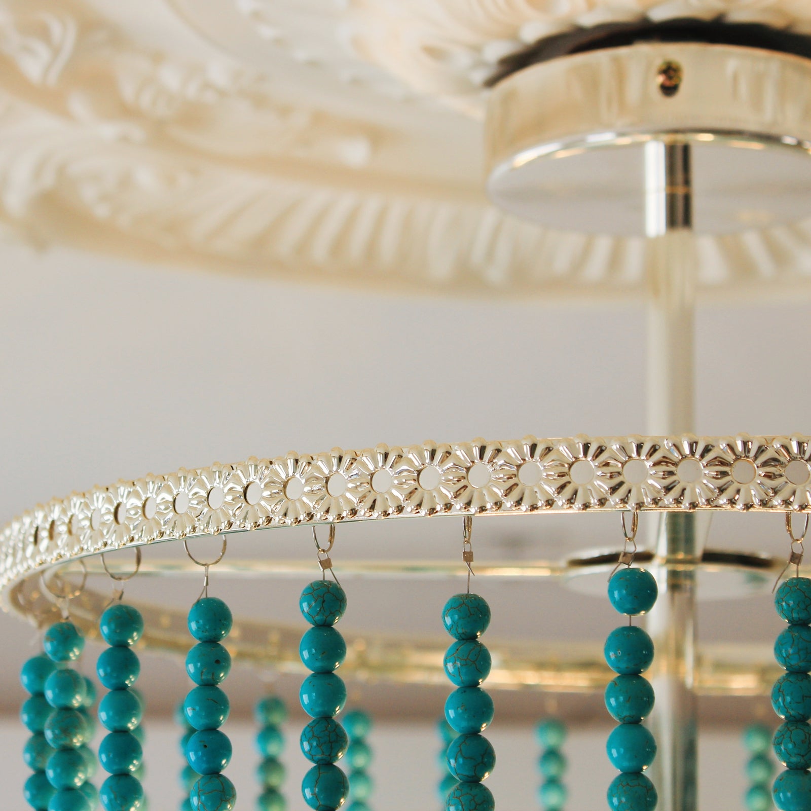 Turquoise beaded chandeliers hangin ceiling